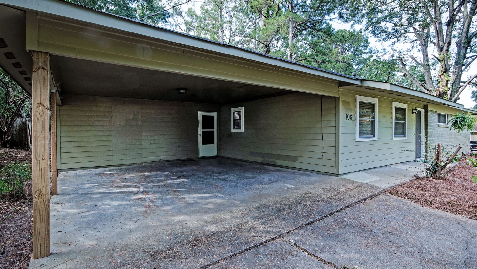 Covered carport with driveway parking