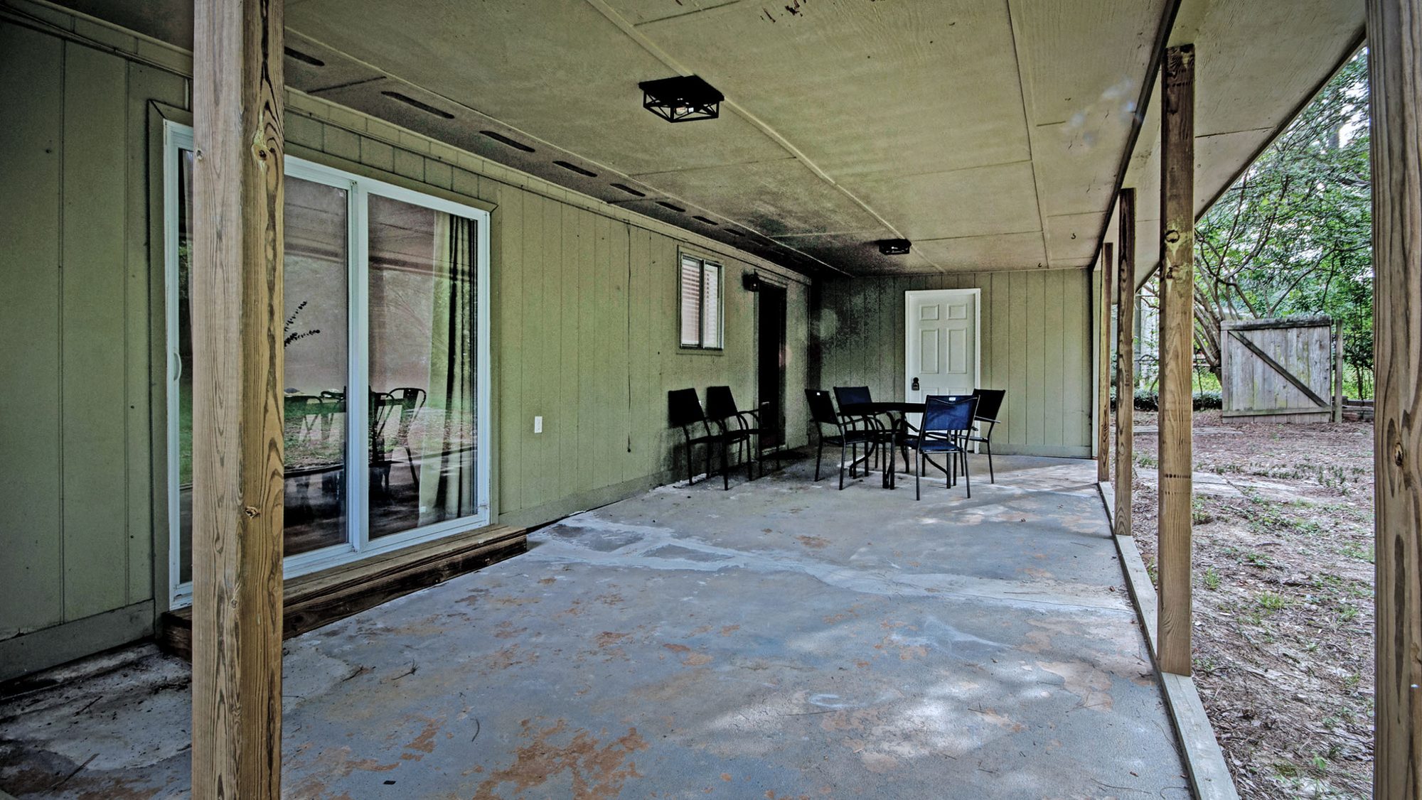 Covered back patio with table and seating