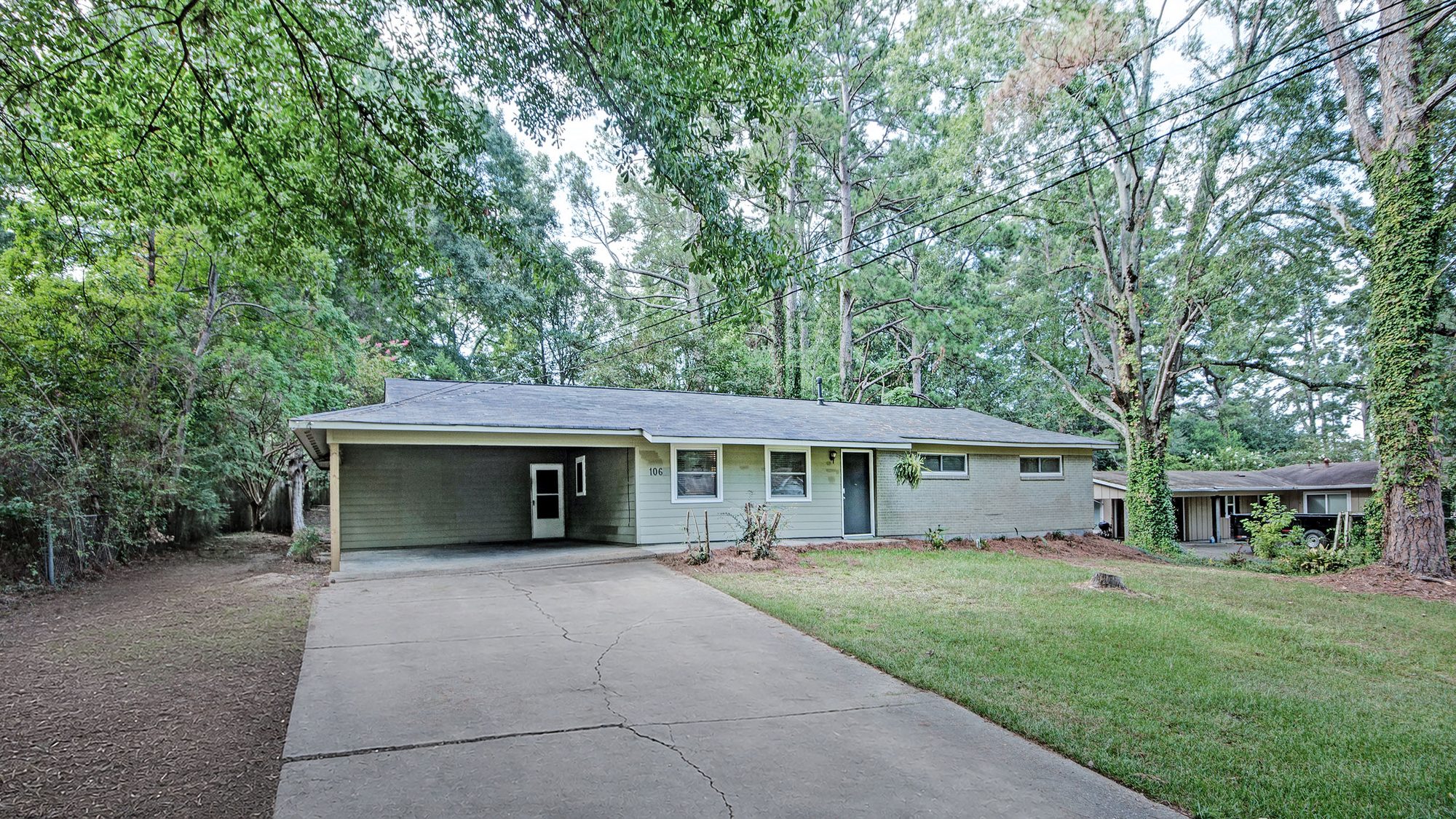 Front exterior of 106 Murial St under mature shade trees