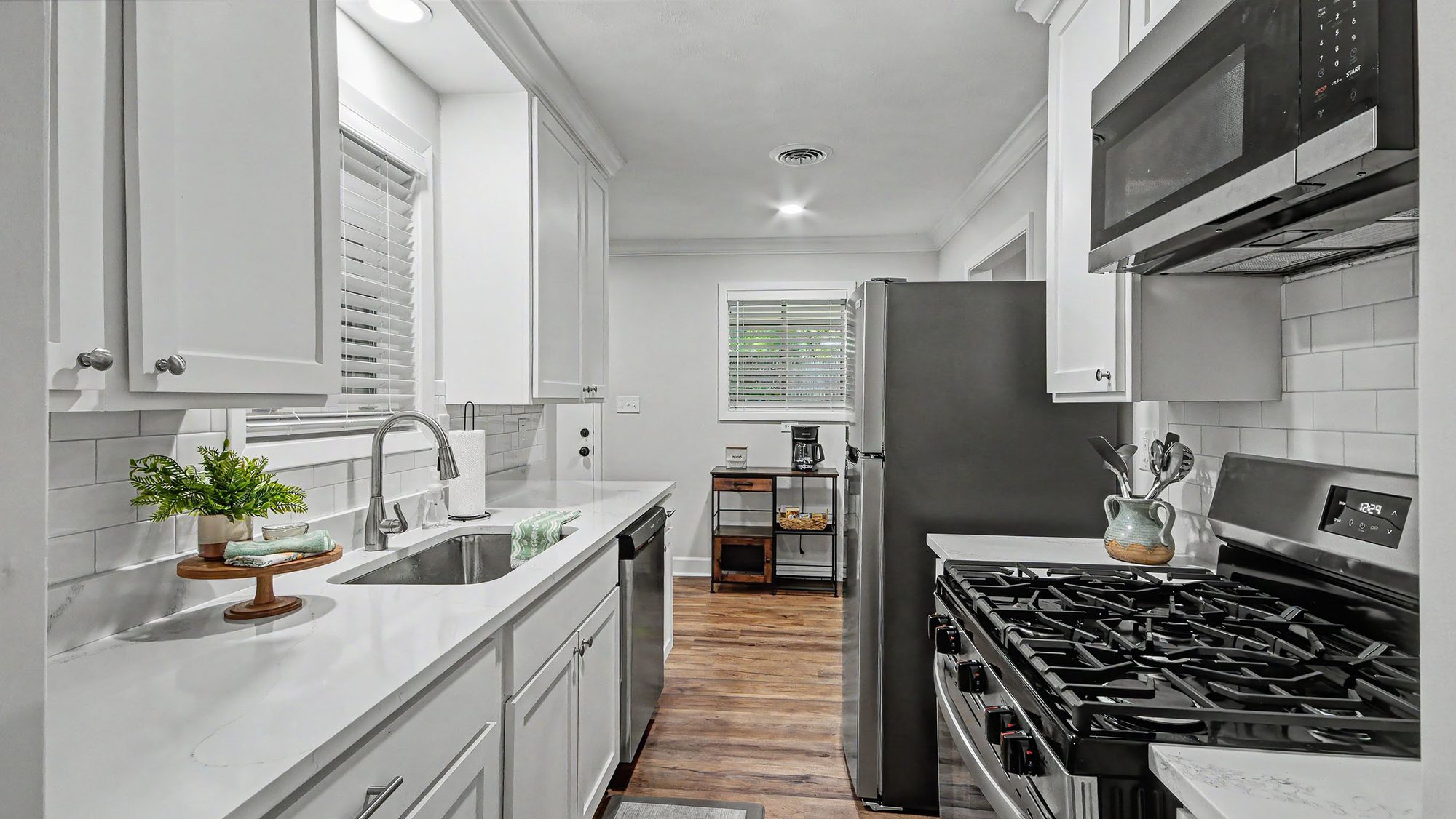 Kitchen with stainless refrigerator and gas range