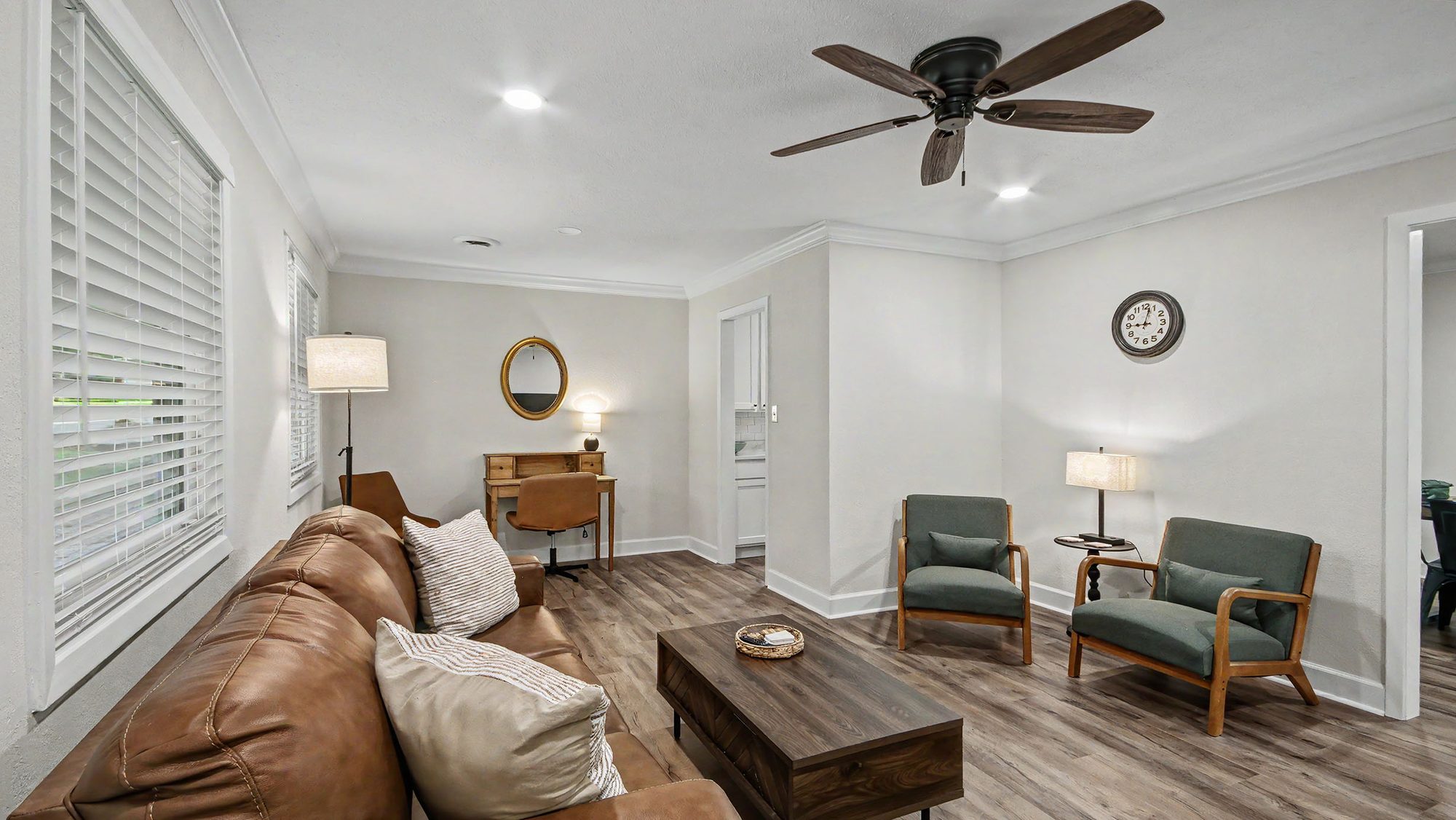 Living room with ceiling fan and accent chairs