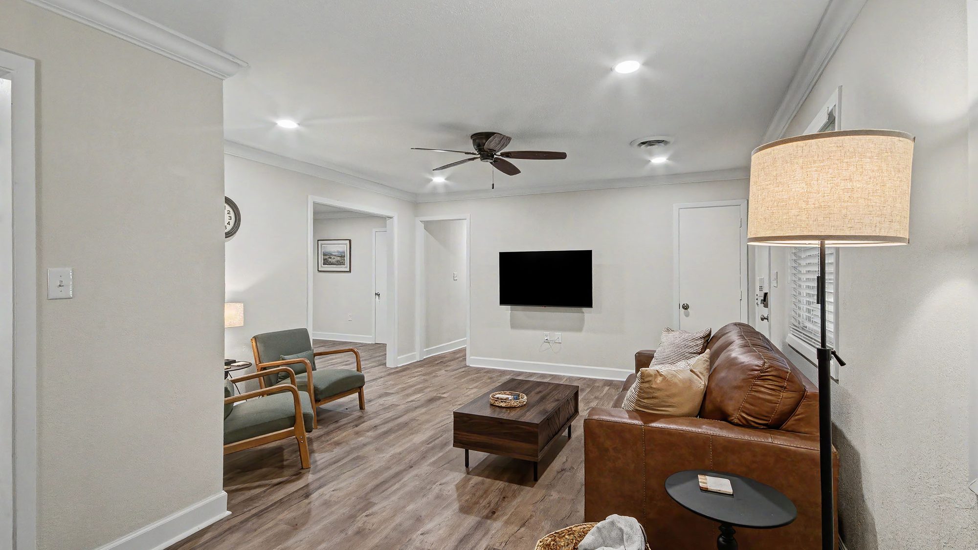 Living area with mounted TV and sofa